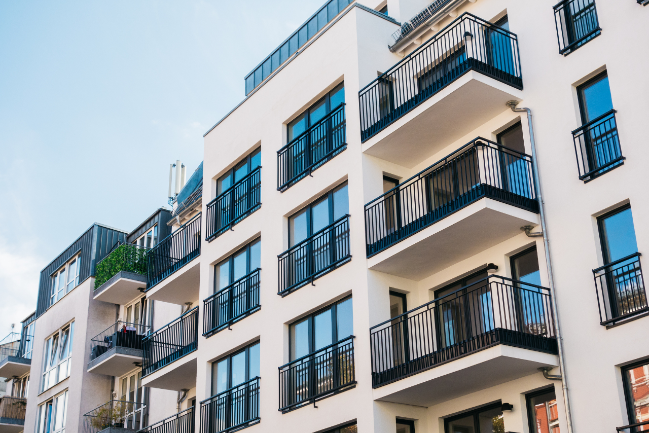 Modern apartment building facade with multiple balconies and glass doors on each floor? or 'door'